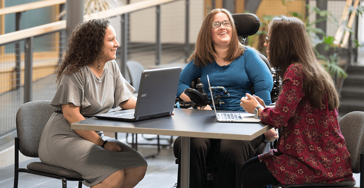 Three women happy on laptop 
