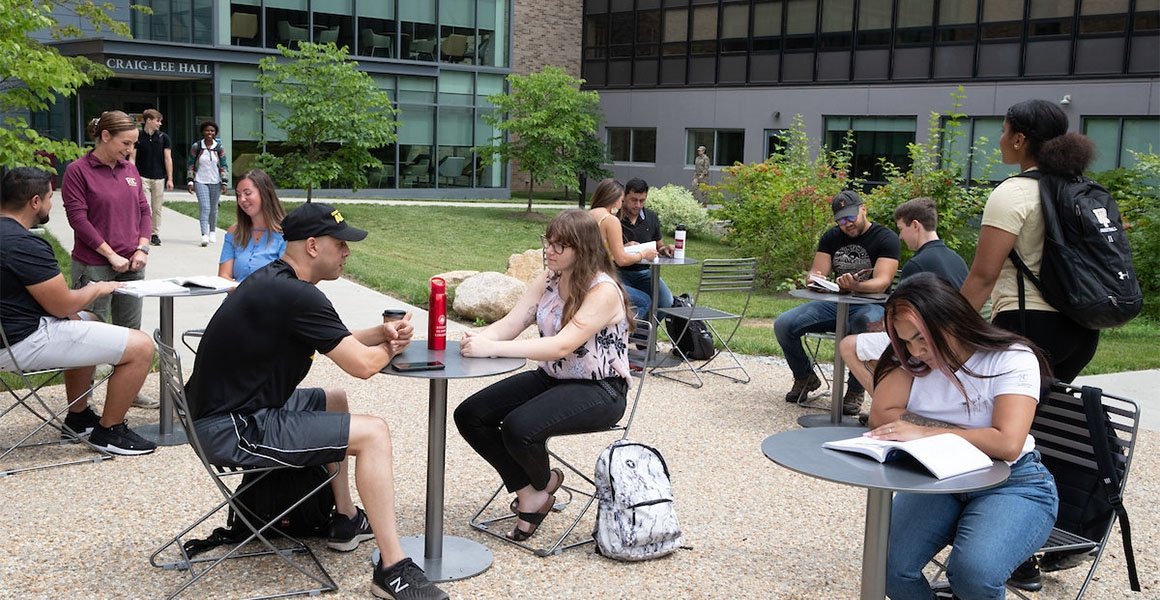 Students at tables outside Craig Lee Hall
