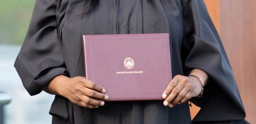 Hands holding a RIC diploma