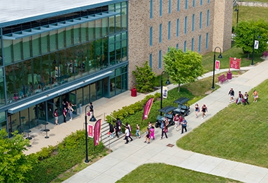 People walking along campus quad pathways