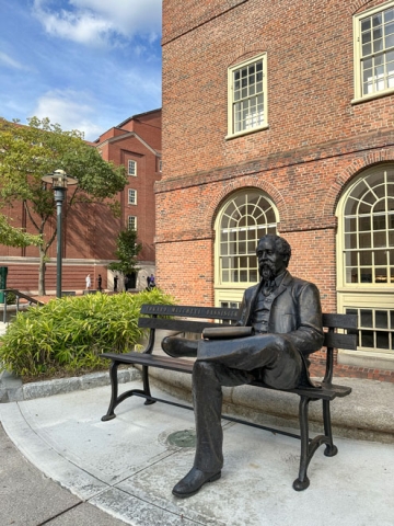 Photograph of a bronze sculpture of Edward Mitchell Bannister seated on a bench