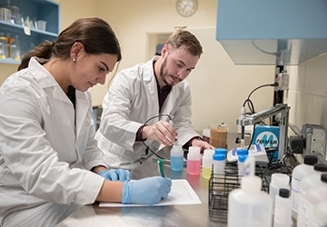 Two biotechnology students working in a lab