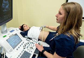 Medical Imaging student working with patient