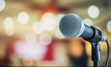 Microphone on stand with lights in the background