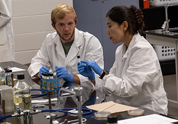 Students working together in lab with equipment