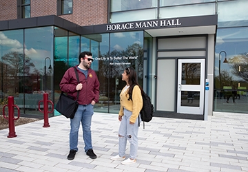 Two students talking outside Horace Mann Hall