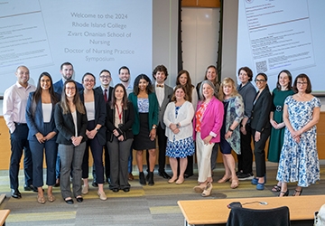 Doctor of Nursing Practice students in group photo at symposium event