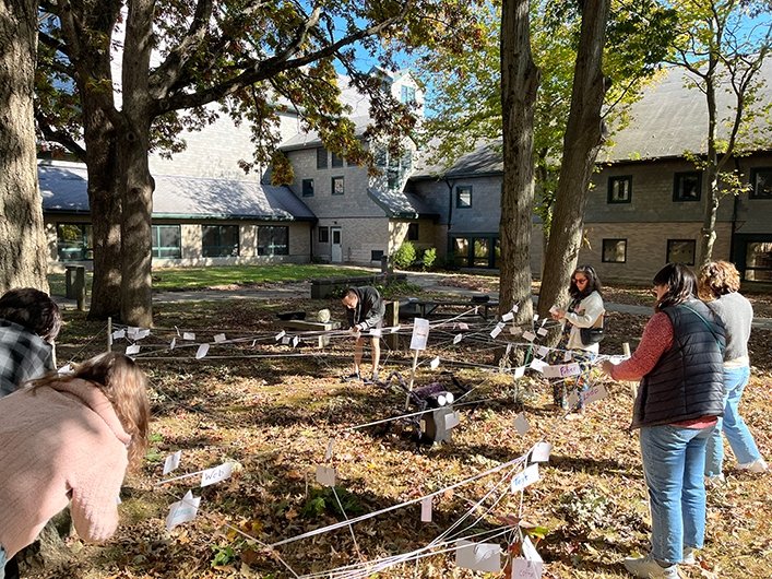 People on campus stringing and staking up words on signs