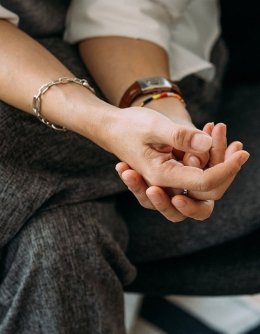 Person resting one of their hands in the other