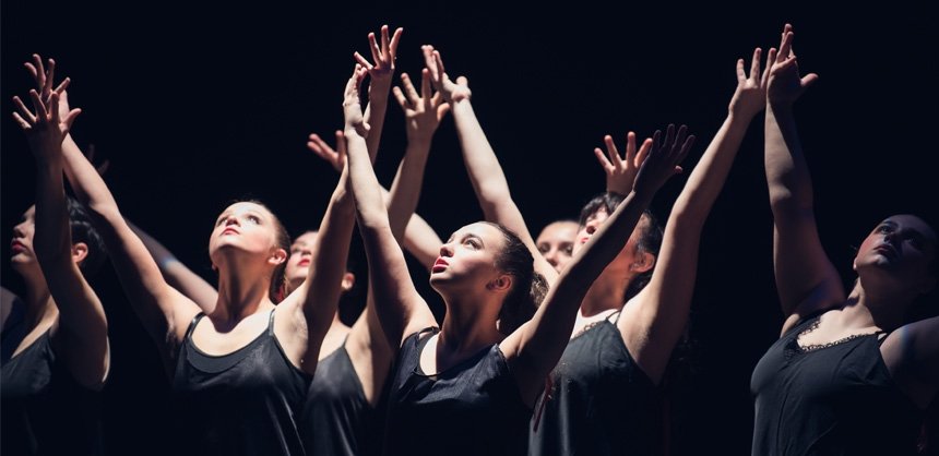 RIC Dance Company members with upstretched arms